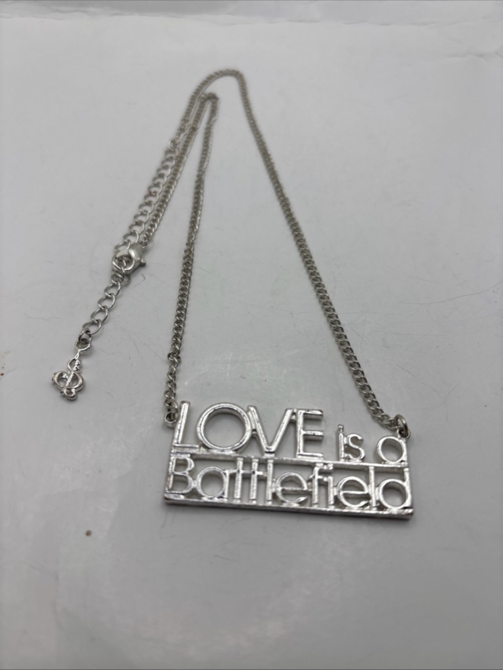 Silver 'Love Is a Battlefield' Pendant Necklace